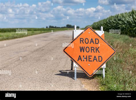 Road Work Ahead Sign On Barricade On Rural Country Asphalt Road Stock