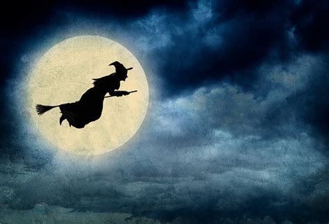 Witch Riding On Broom In Front Of Hazy Full Moon Stock Photo Download
