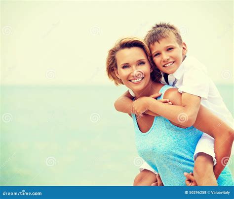 Happy Mother And Son Having Fun On The Beach Stock Photo Image Of