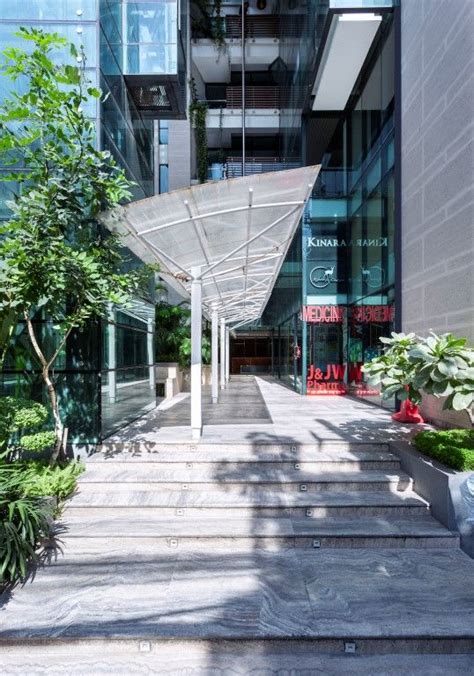 An Outdoor Walkway In Front Of A Tall Building