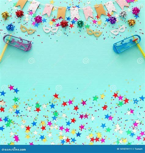 Party Colorful Confetti With Noisemaker Over Light Pastel Blue Wooden