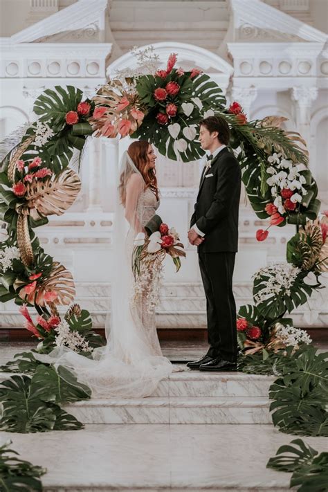Benefitting often from the use of hanging flower garlands that can be wrapped or draped, standing beneath wedding arch flowers is a brilliant way to begin a marriage. Trendy Tropical Glam Wedding Ideas in White and Gold