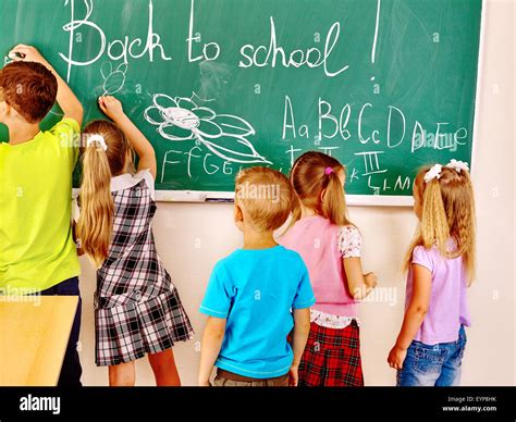 Children Writing On Blackboard Stock Photo Alamy