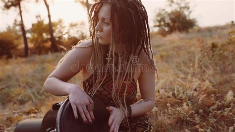 Portrait Of An Attractive Hippie Woman With Dreadlocks In The Woods At