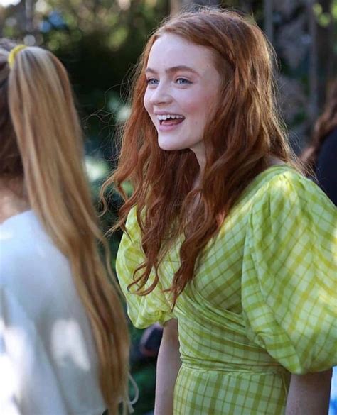 A Girl With Red Hair Is Smiling And Standing Next To Another Girl In A Green Dress