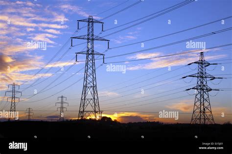 Electricity Pylons At Sunset Stock Photo Alamy