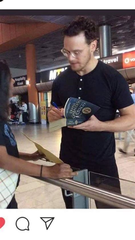 Sam Heughan With Glasses Signing An Autograph For A Fan Sfter Returning