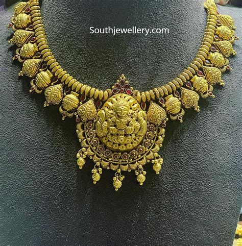 traditional gold necklace with lakshmi pendant indian jewellery designs