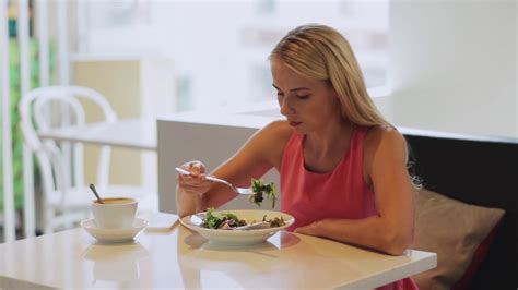 Food People And Leisure Concept Hungry Woman Eating Salad For Lunch With Coffee At Restaurant