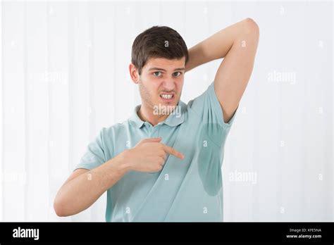 Young Man With Hyperhidrosis Pointing To A Sweat Armpit Stock Photo Alamy