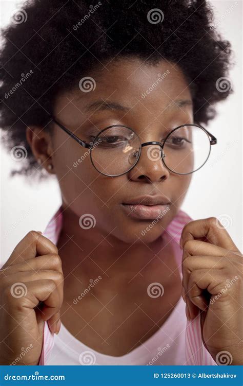 Afro Woman In Glasses Looking Aside And Holding The Collar Of A Shirt
