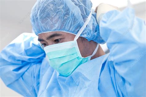 Male Surgeon Putting On Surgical Mask Stock Image F0205311