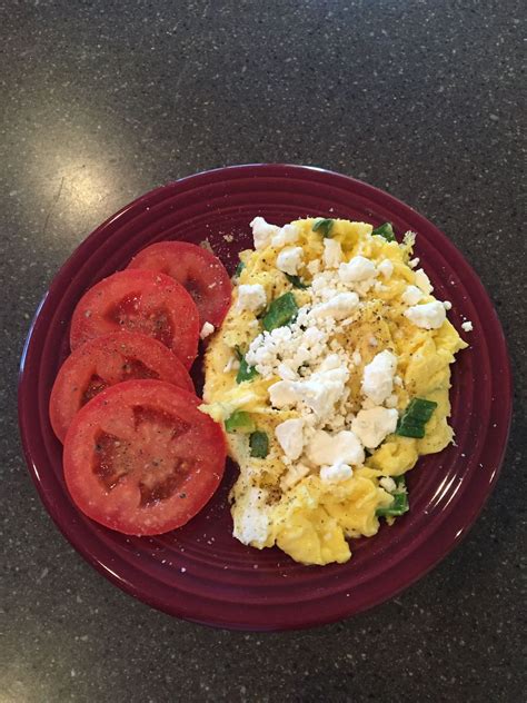 2 Scrambled Eggs With Green Onion Feta Cheese And Sliced Plum Tomatoes