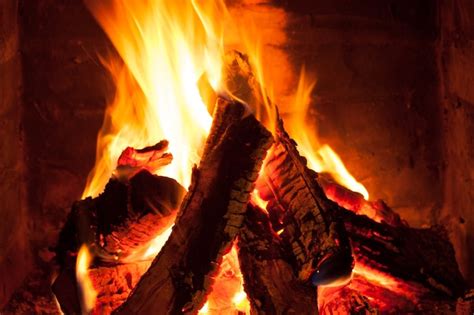 premium photo burning fire in the brick fireplace close up