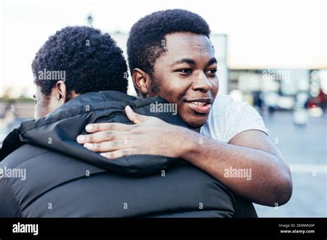 Two Male Friends Hugging And Laughing Hi Res Stock Photography And