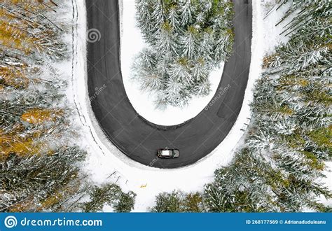 Aerial View Of Car On Winding Road In Snowy Winter Forest Stock Image
