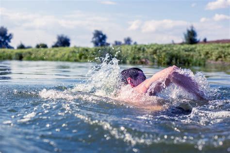 The Young Man Swimming In The River Stock Photo Image Of Exercise