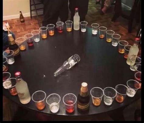 There Are Many Glasses And Bottles On The Table With Drinks In Them All Arranged In A Circle