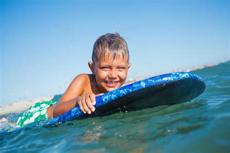 Boy Has Fun With The Surfboard Stock Image Image Of Board Horizontal