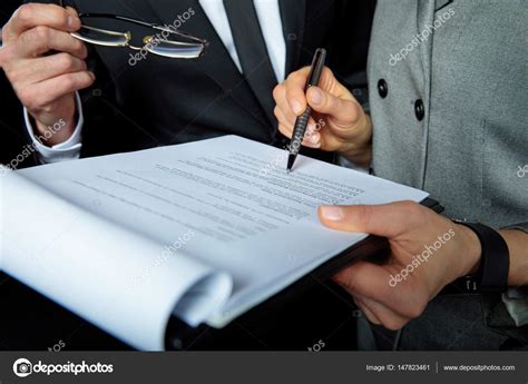 Businesspeople Signing Papers — Stock Photo © Yurasokolov 147823461