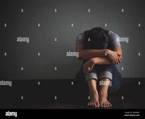 Sad Woman Hug Her Knee And Cry Sad Woman Sitting Alone In A Empty Room Stock Photo Alamy