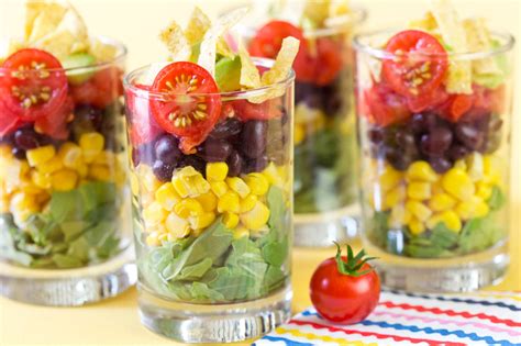 Individual fruit cups of grapes, strawberries, melons, blueberries, and red raspberries, served in waffle bowls, made a lovely. Mini Layered Southwestern Salads | Pizzazzerie