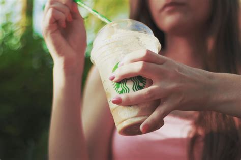 Woman Holding Starbucks Coffee Cup · Free Stock Photo