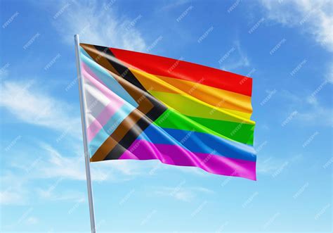 Premium Photo | Progress Pride rainbow flag waving in a blue sky