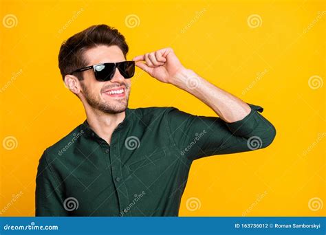 Photo Of Cheerful Positive Cool Man In Sunglass Looking Far Away