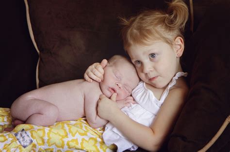 Big Sister Holding Her New Baby Brother Holly Von Buchler Photography