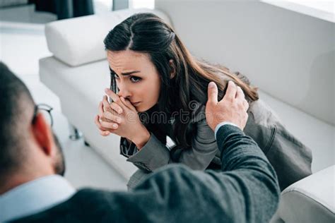 Psychologist Touching Shoulder Of Crying Patient In Doctors Stock Image