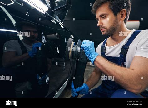 Caucasian Repairman Polishing Body Of Car In Automotive Service Stock