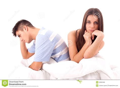 A Young Sad Couple In Bed Having Problems And Cris Stock