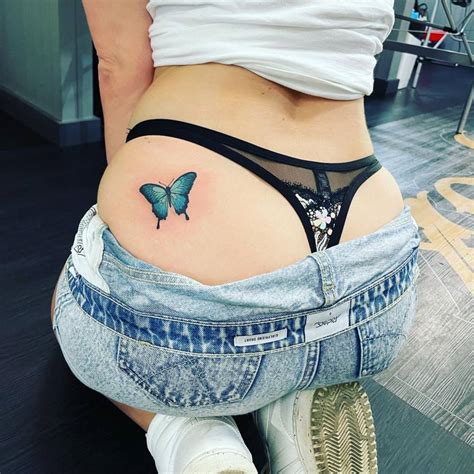 Blue Butterfly Tattooed On The Butt Cheek