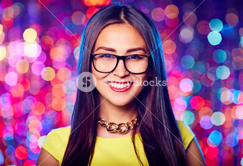 Asian Female In Eyeglasses Looking At Camera At Party Royalty Free