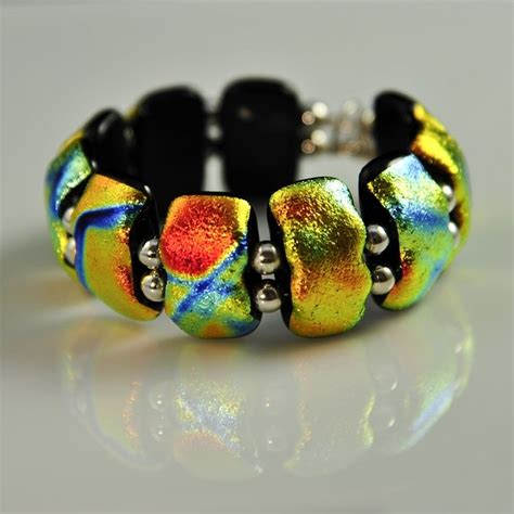 this is a dichroic glass bracelet made from fused components in the hot lava series