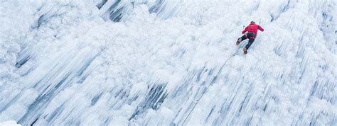 Ice Climber Ascending A Frozen Waterfall Stock Photo Download Image