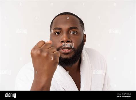 black guy wearing a bathrobe pointing finger with surprise and happy emotion isolated over