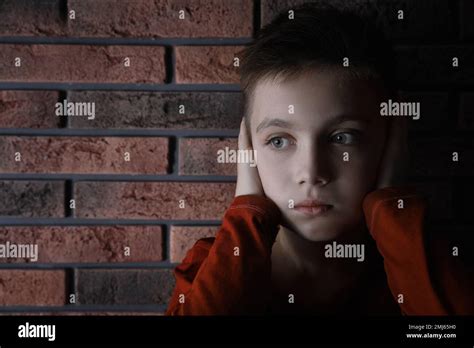 Sad Little Boy Closing His Ears Near Brick Wall Domestic Violence