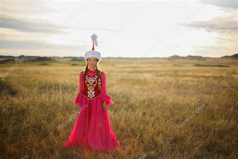 Beautiful Kazakh Woman In National Costume In The Steppe Dancing With Dombyra Stock Photo