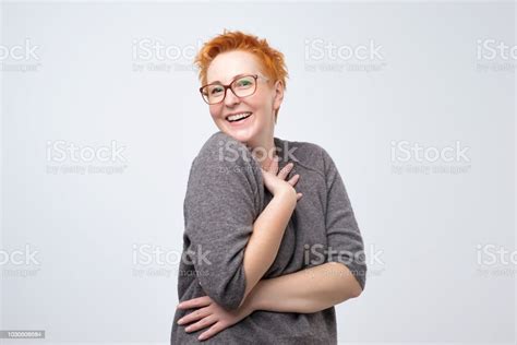 Pretty Caucasian Mature Woman With Short Red Hairstyle In Simple