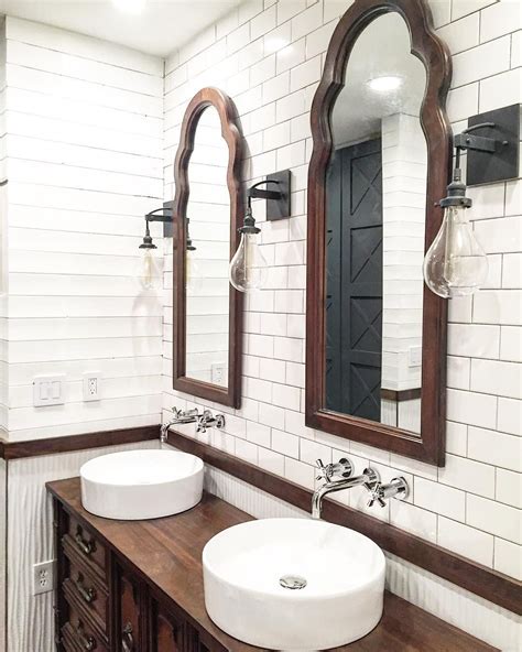 Rustic mirror with frame built out of this farmhouse bathroom looks beautiful with its wooden accents, which break up the light and rustic bathroom with wood shelving, white subway tile, mosaic floor tile and glass shower tub. Rustic farmhouse bathroom design with plank walls and ...