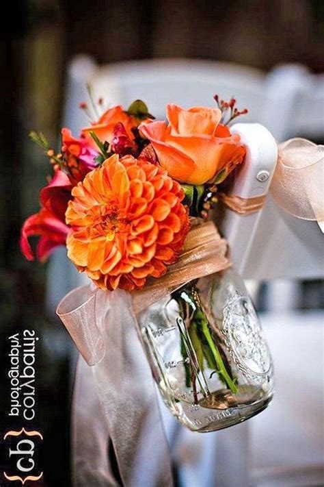 An Orange Flower Arrangement In A Mason Jar
