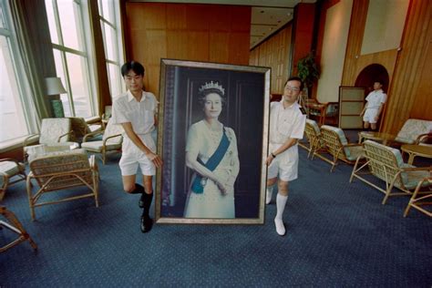 A Portrait Of Queen Elizabeth Ii Is Removed From The British Forces