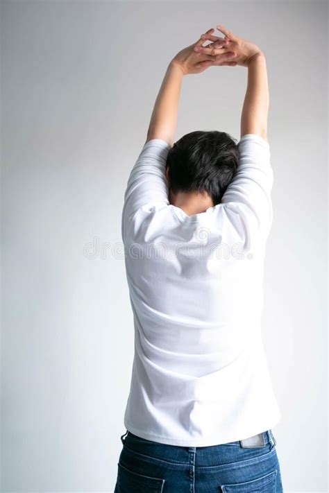 Back Of Woman Stretching Arms Over Head For Stretch Muscle And Exercise