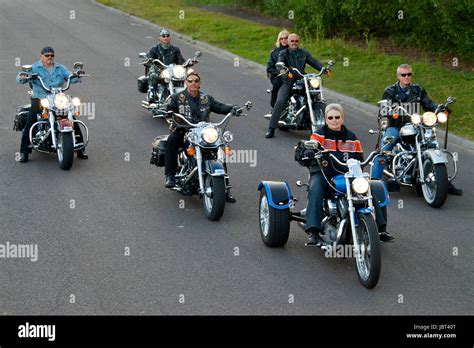 A Group Of Harley Davidson Motorcycle And Riders On The Road Stock