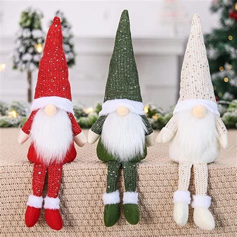 Three Christmas Gnomes Are Sitting On A Table