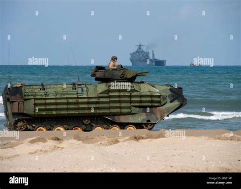 An Us Marine Corps Amphibious Assault Vehicle Arrives On Shore In