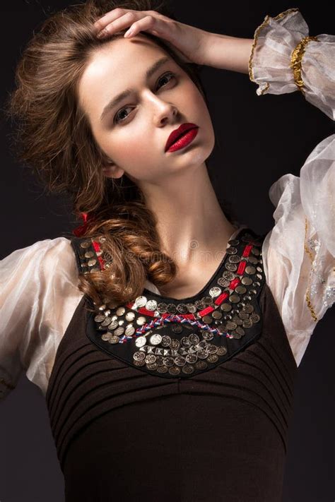 beautiful russian girl in national dress with a braid hairstyle and red lips beauty face stock