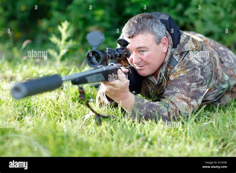 Sport Gun Shooting Sniper Wearing Camoflage Holding Rifle With